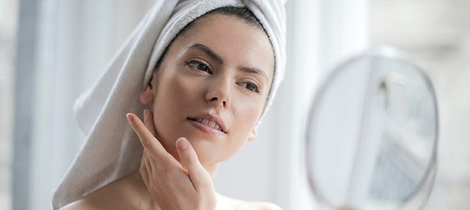 woman looking into a mirror